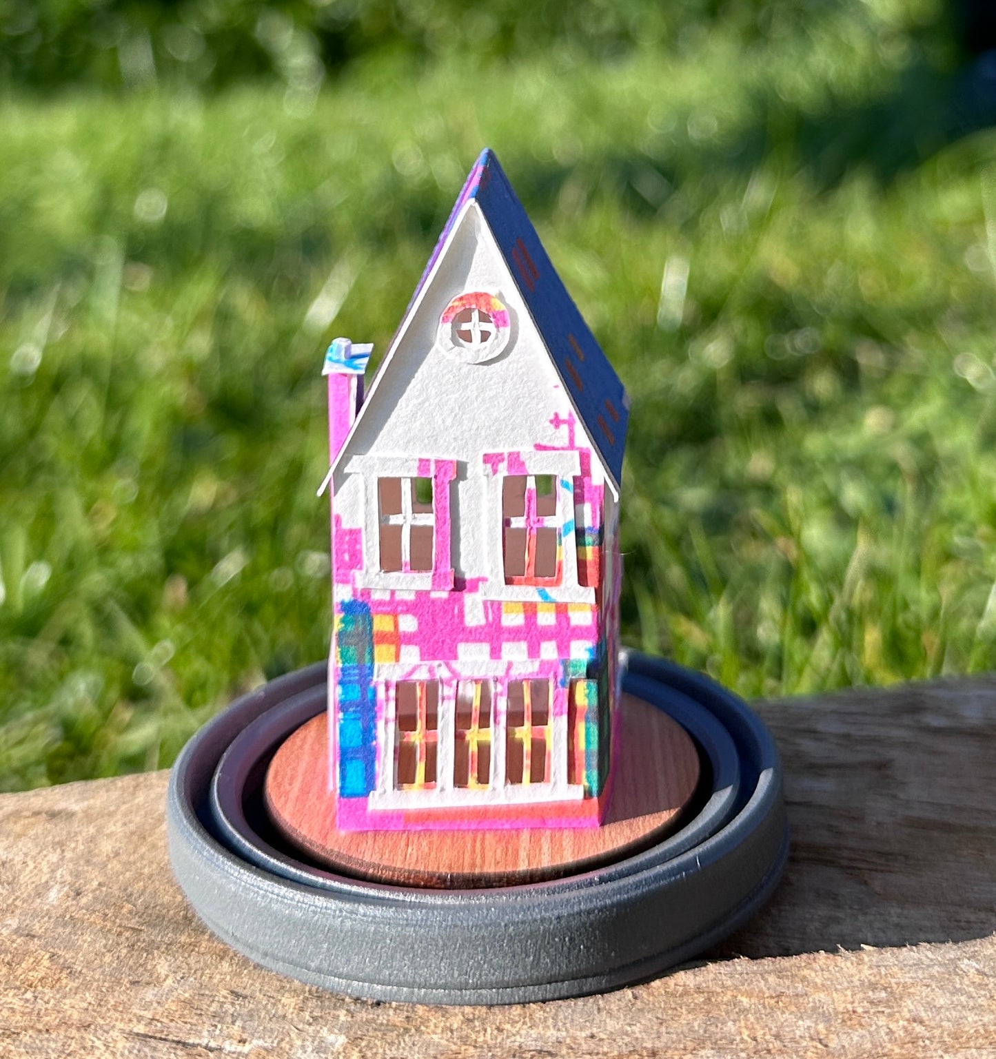 Rear elevation of gable roofed house made from multicoloured paper 