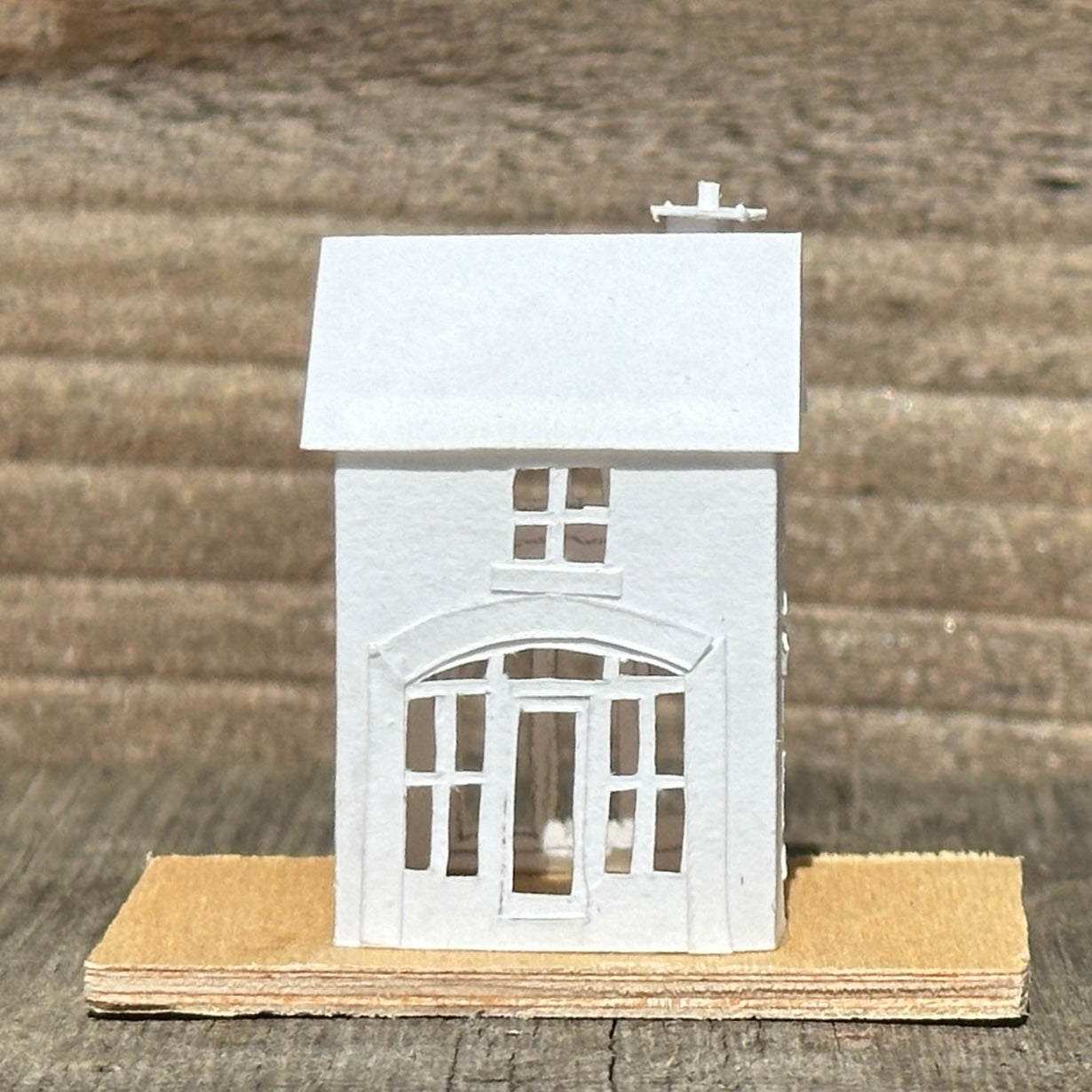 white paper coach house on plywood base