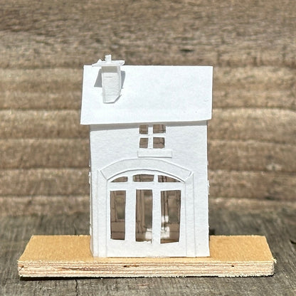 white paper coach house on plywood base