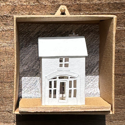 white paper coach house on plywood base in presentation box