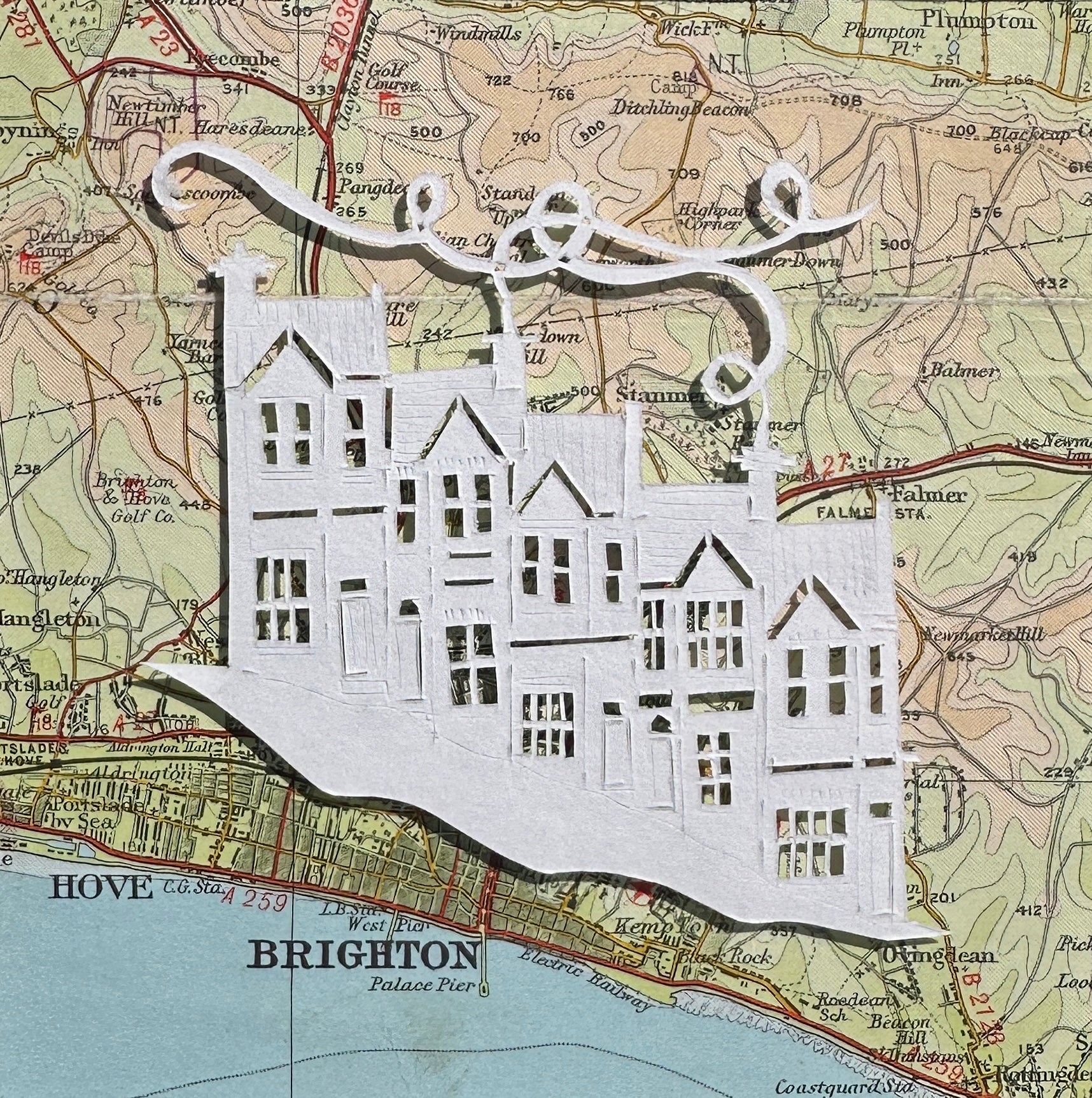 papercut of 5 houses on hillside on OS map extract