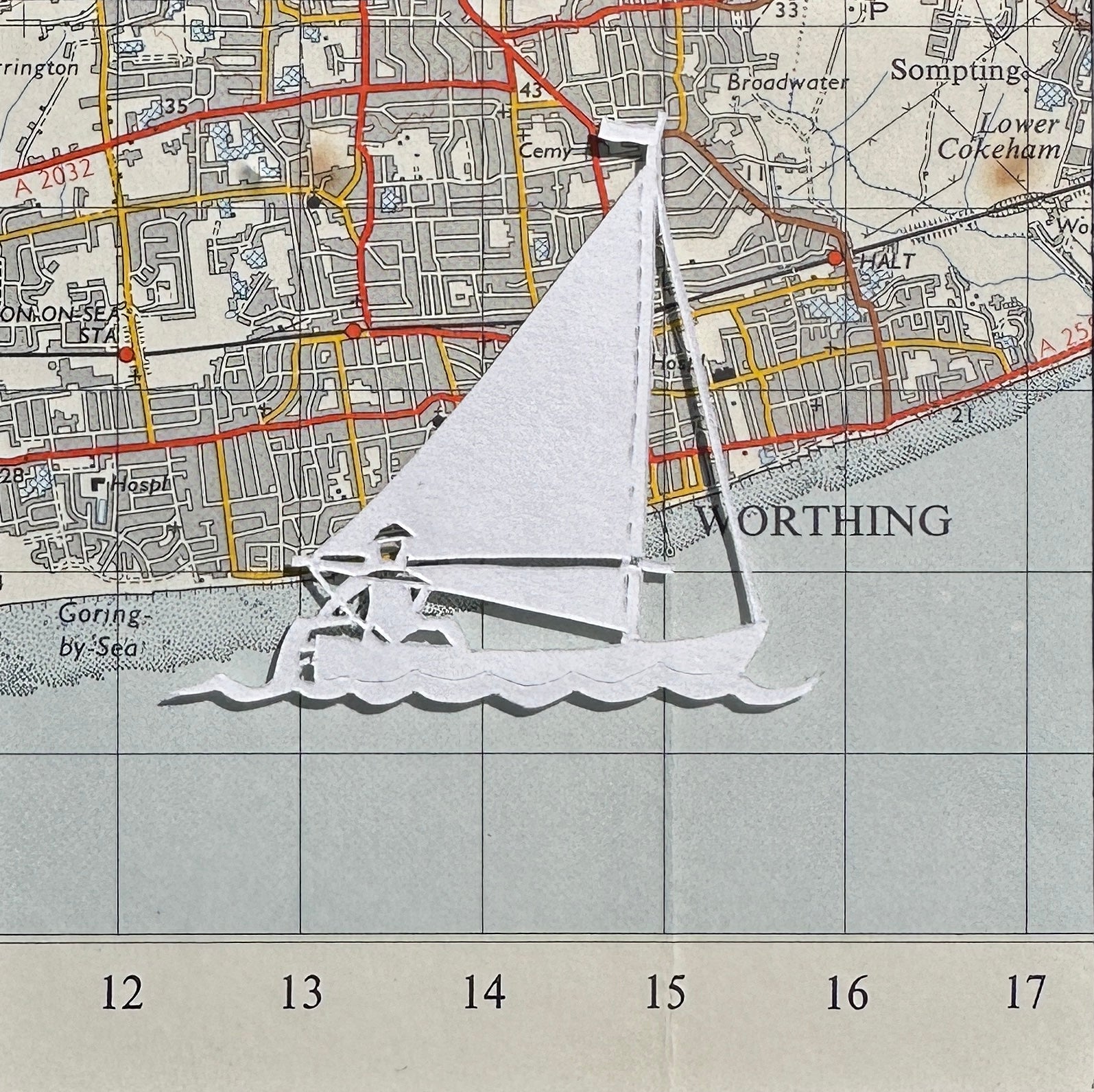papercut sailing boat over OS map extract